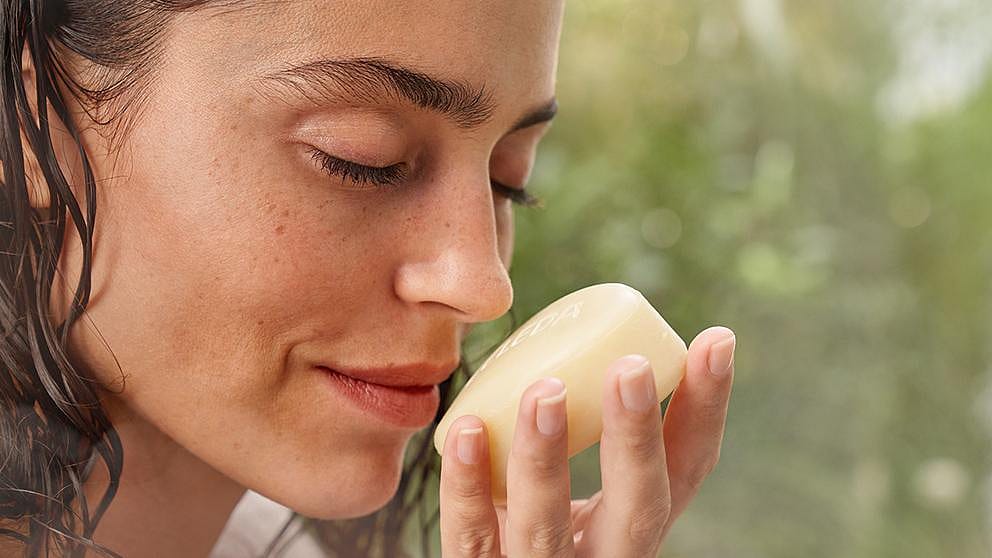Woman smelling soap